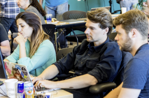 Maria Lopez Latorre, Manu Koenig and Robert Singleton from Civinomics work on their project for the TechRaising finale. (credit: Darren Odden @ ocm.today)