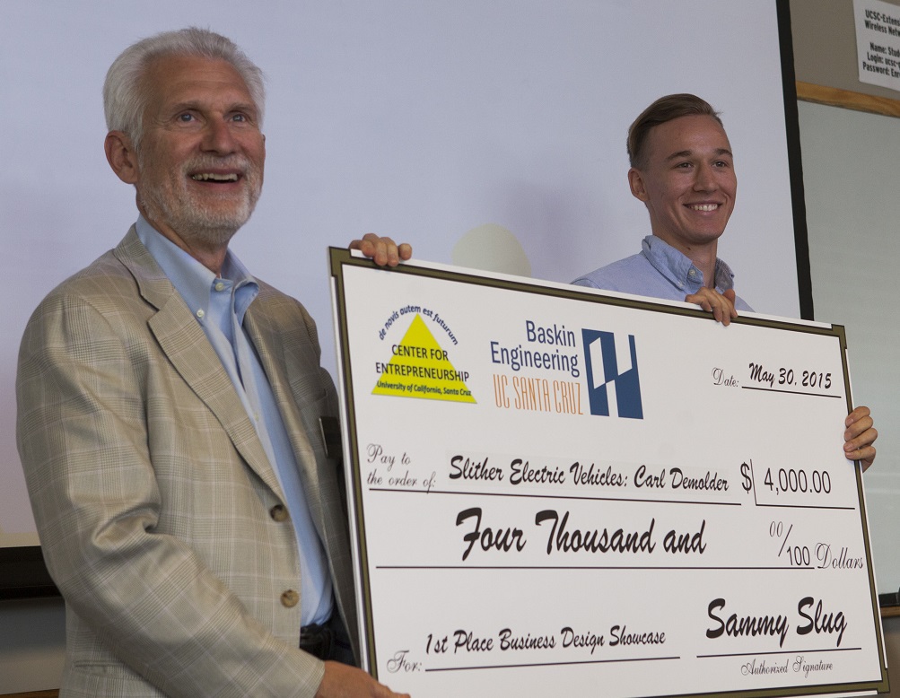 Left to right: BSOE Interim Dean Joseph Konopelski and 1st-Place Winner Carl Demolder for his Slithr Electric Vehicles (remote-controlled longboards). Credit: Tosh Tanaka.