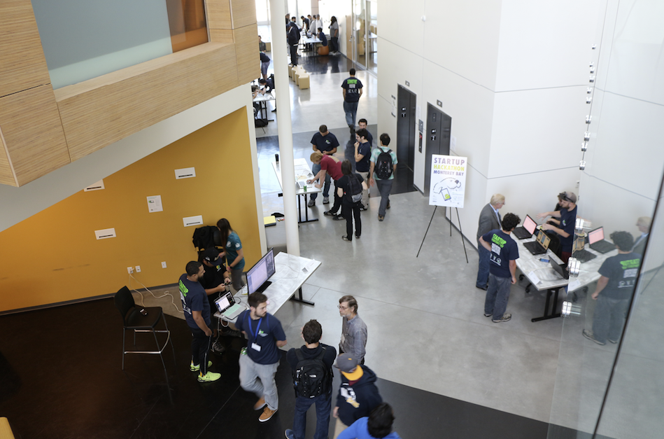 On Sunday, teams prepared tabletop presentations of their newly designed apps throughout the main walkways of the building to create experiential engagement for the judges. (Credit: Jan Janes Media)