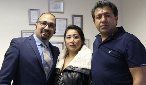 Jacob Martinez, (l) with Daisy's parents Veronica Martinez and Adolfo Ramirez, in the classroom commemorating her work with young women. (Credit: Jan Janes Media)