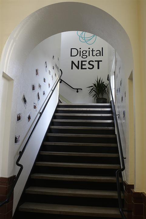 Stairways decorated with DigiNEST student photos and projects lead the way to second floor classrooms. (Credit: Jan Janes Media)