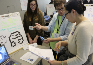 Garrett Tibbetts (center) walks Judge Bude Su, CSUMB SCD department chair, through the "Otter Tour" campus navigation game while Monique La Croix looks on.