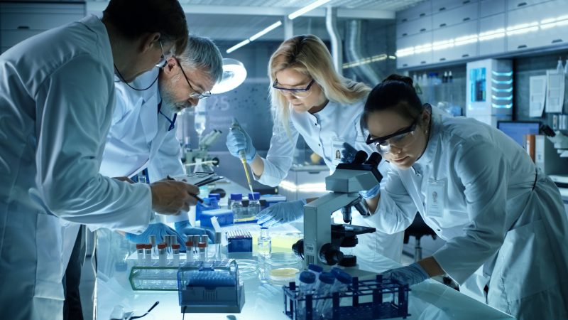 Medical researchers doing research using microscopes and samples