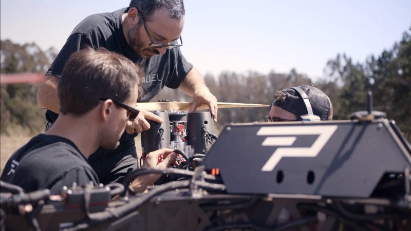 Joshua and co-founders inspect the Hybrid Power Module before takeoff