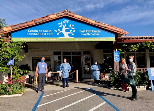 Medical workers in protective gear outside East Cliff Family Health center in Santa Cruz, CA